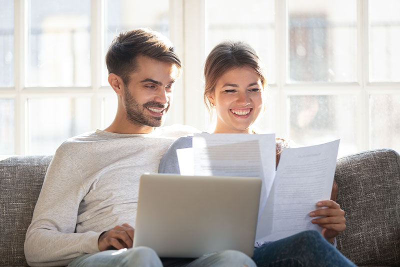 Couple reviewing loan docs on the couch